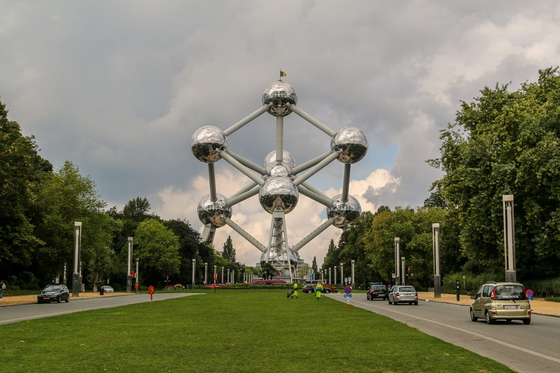 car, travel destinations, tree, day, sky, Brussels, Atomium, grass, motor vehicle, cloud - sky, city, plant, Belgium, park, built structure, incidental people