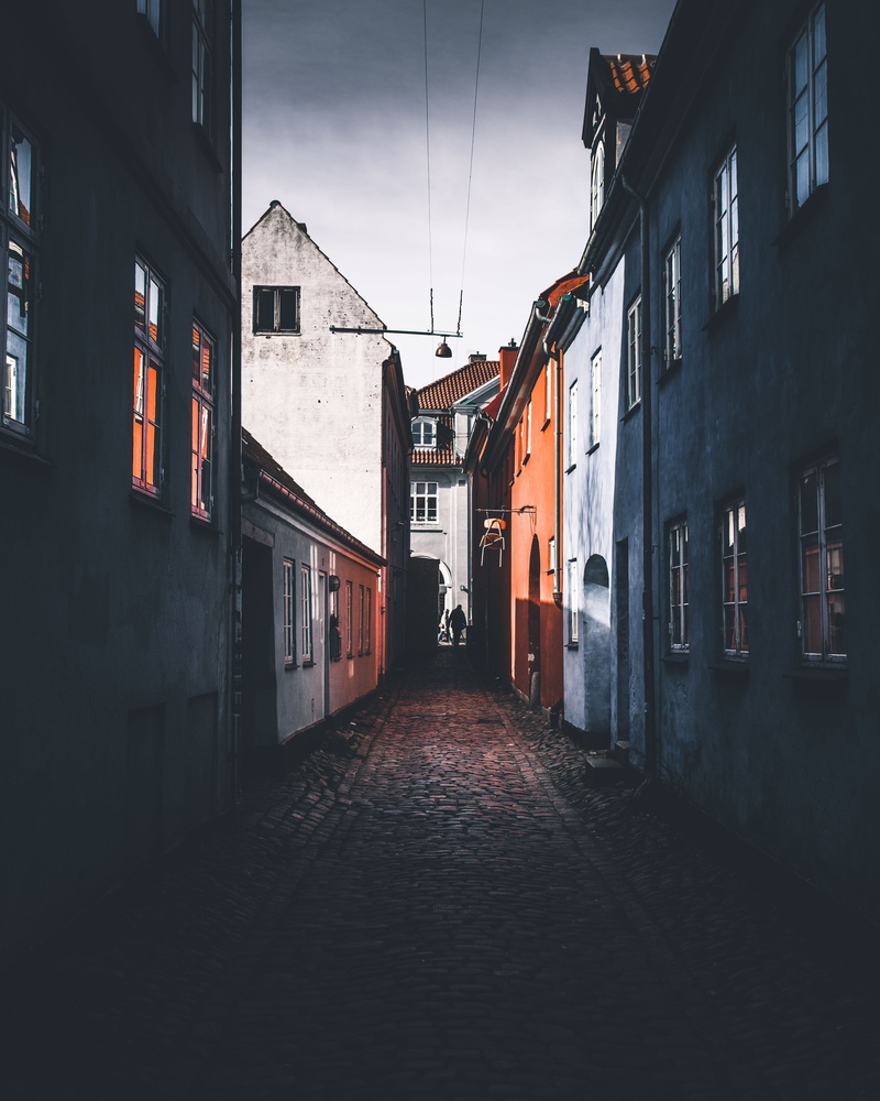 alley, person, house, building, residential district, outdoors, home, street, sky, building exterior, mood, direction, transportation, dark, no people