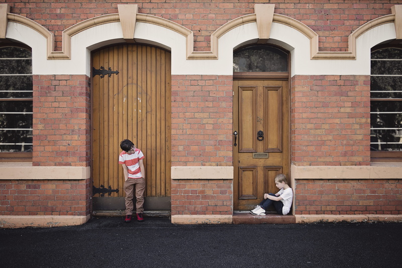 building, outdoors, two people, doorway, lonely, bricks, innocence, day, town, full length, casual clothing, hands, standing, brick, brothers, girls, childhood