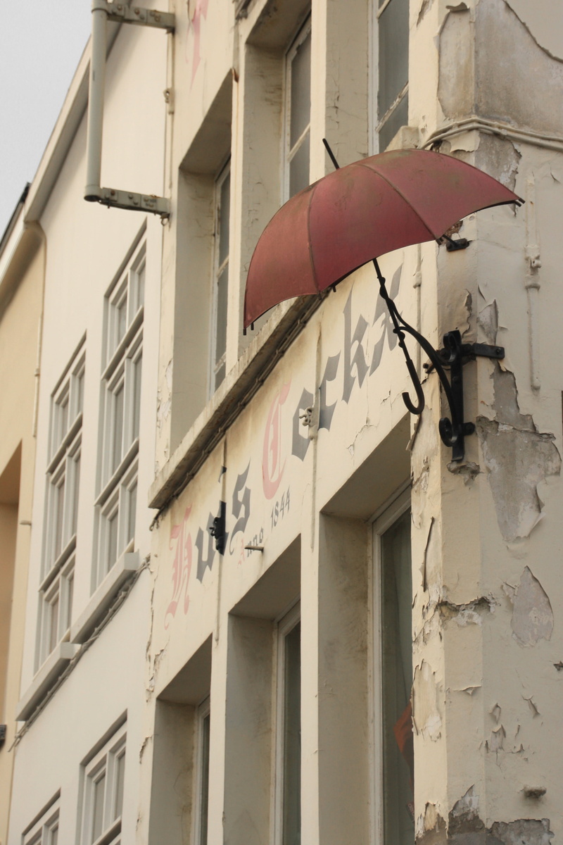 houses facades, electric lamp, trist, western script, no people, entrance, old buildings, wall, old, grey, sign, historic home, city, communication, detail