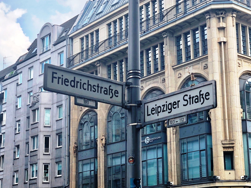 architecture, road, friedrichstrasse, built structure, communication, nature, western script, text, low angle view, 2K, sky, road sign, leipziger strasse