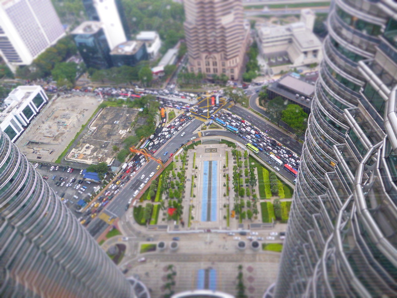 outdoors, high angle view, modern, cityscape, built structure, skyscraper, malaysia, traffic, nature, petronas towers, mode of transportation, financial district