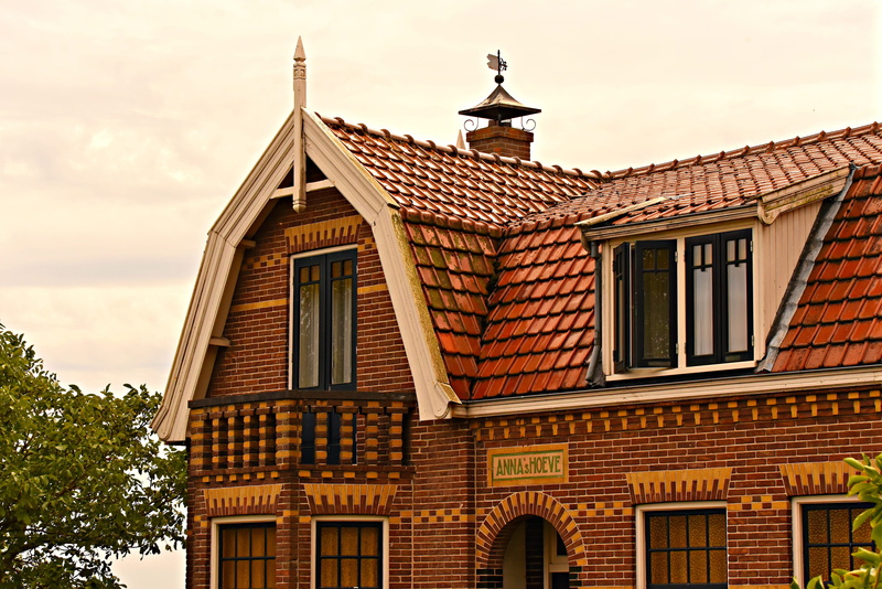 cloud - sky, balcony, upper story, nature, tree, place of worship, sky, window, religion, dutch, building, day, low angle view, architecture, dormer window