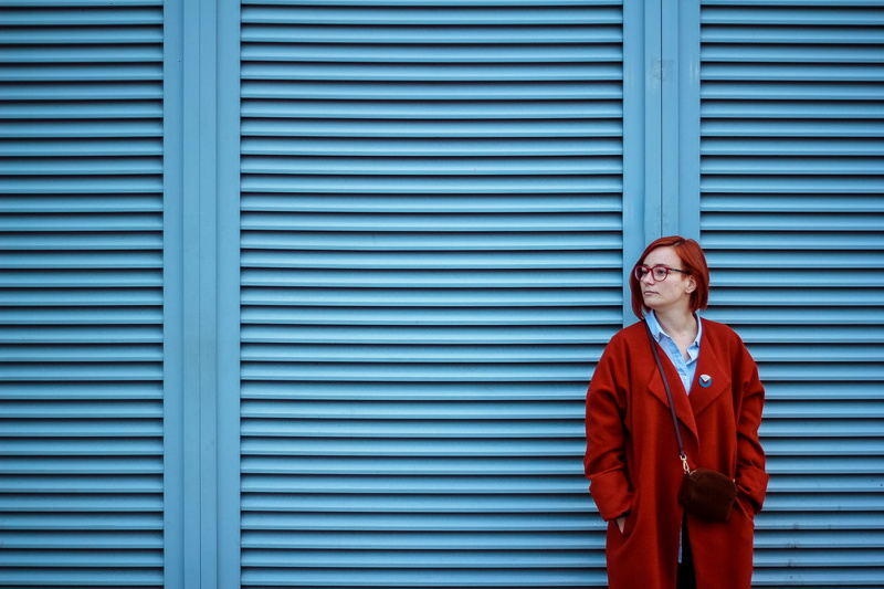 2K, standing, adult, architecture, person, shingles, apparel, jacket, glasses, near, coat, curtain, stripes, mid adult, suit, emotion, looking at camera