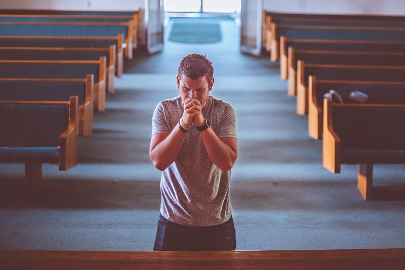 lifestyles, wooden, architecture, seat, wood - material, young men, built structure, kneel, real people, praying, belief, staircase, indoors, casual clothing