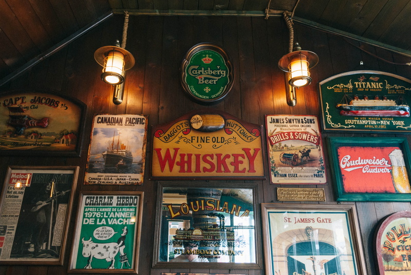 low angle view, posters, store, yellow, ceiling, choice, large group of objects, representation, built structure, retro, arrangement, lights, vranje, whiskey