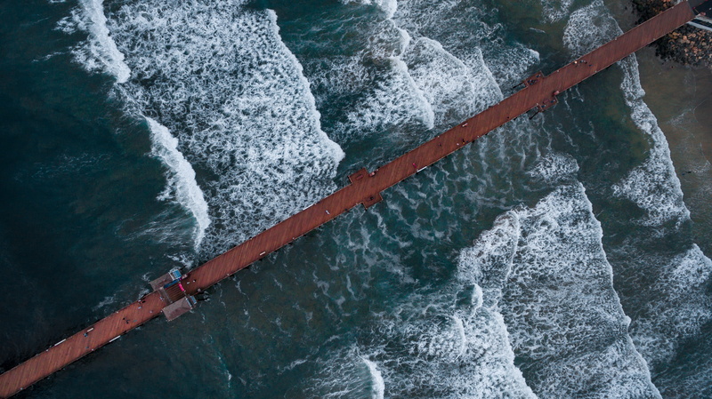 water, aquatic sport, solid, high angle view, looking down, day, rope, blurred motion, drone, beach, brown, wave, drone beach, beauty in nature, fly, clear