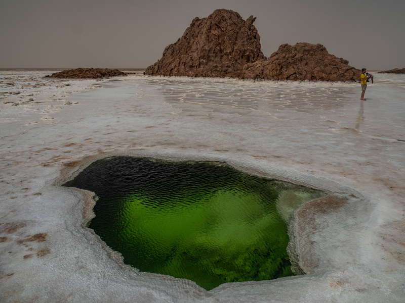 person, 5K, rock, rock formation, bird, human, water, solid, nature, day, standing, tranquil scene, mountain, beauty in nature, hole, wildlife, salt flat
