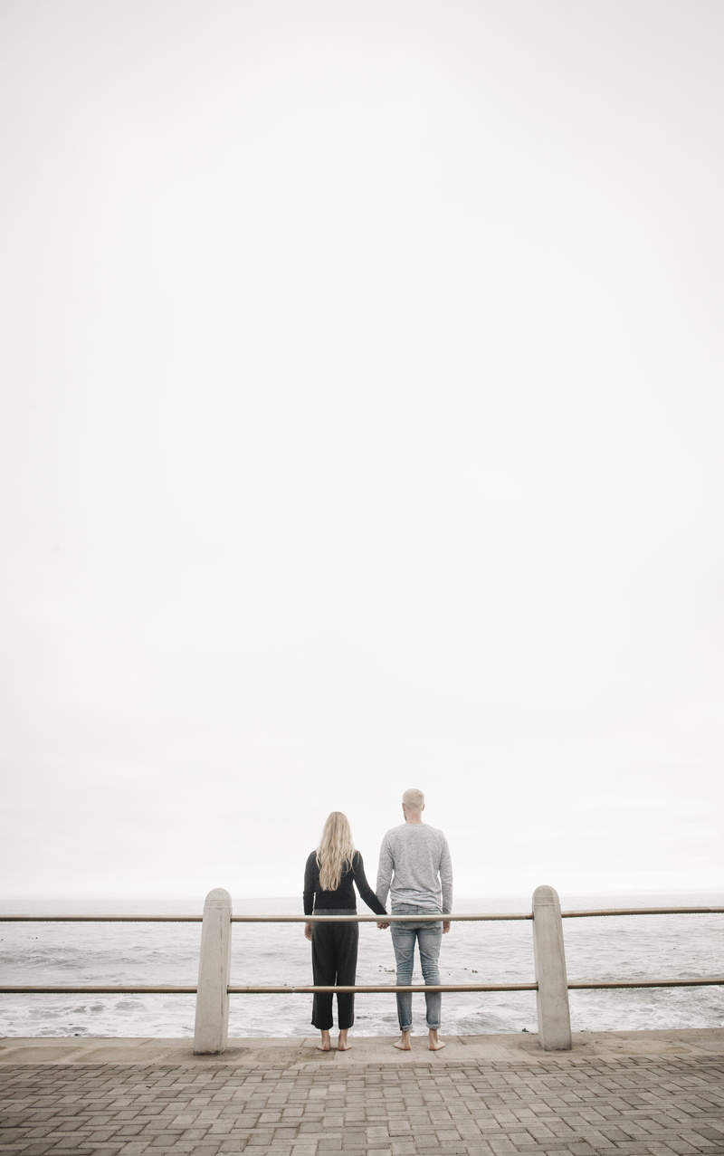 women, water, fence, senior men, sea side, outside, looking out, sidewalk, men, daytime, adult, expression, rear view, sky, blonde, holding hands, body