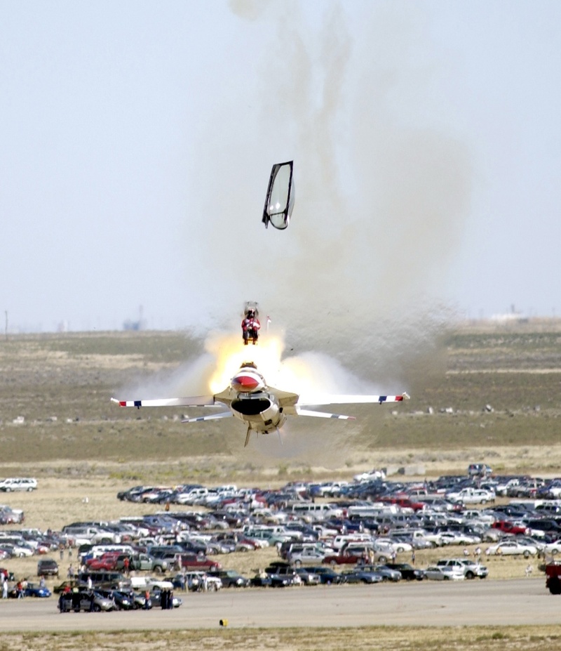 airport runway, day, sky, outdoors, air vehicle, motor vehicle, smoke - physical structure, fighter jet, ejection seat, mode of transportation, land vehicle