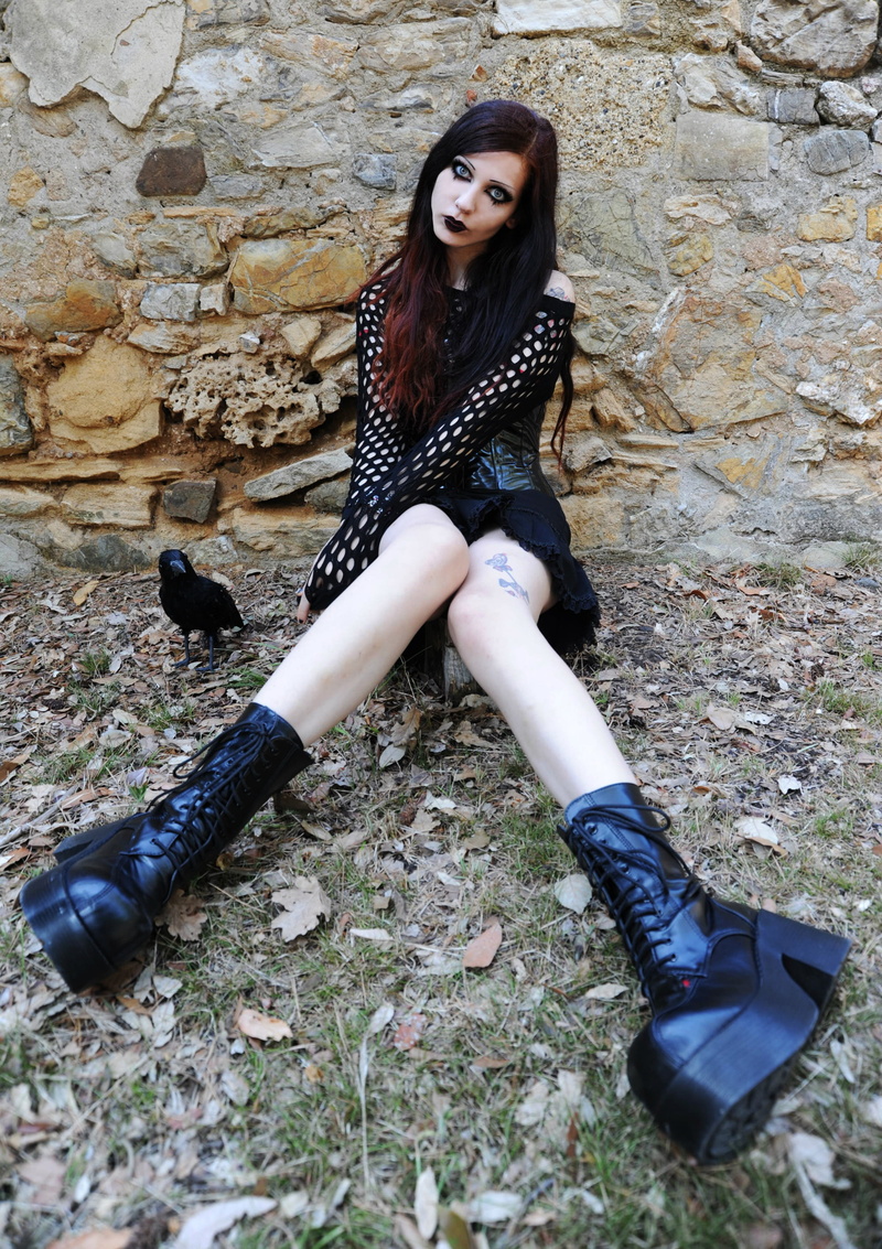 looking at camera, one person, stone wall, outdoors, shoe, casual clothing, young women, black boots, women, Gothic, portrait, real people, front view