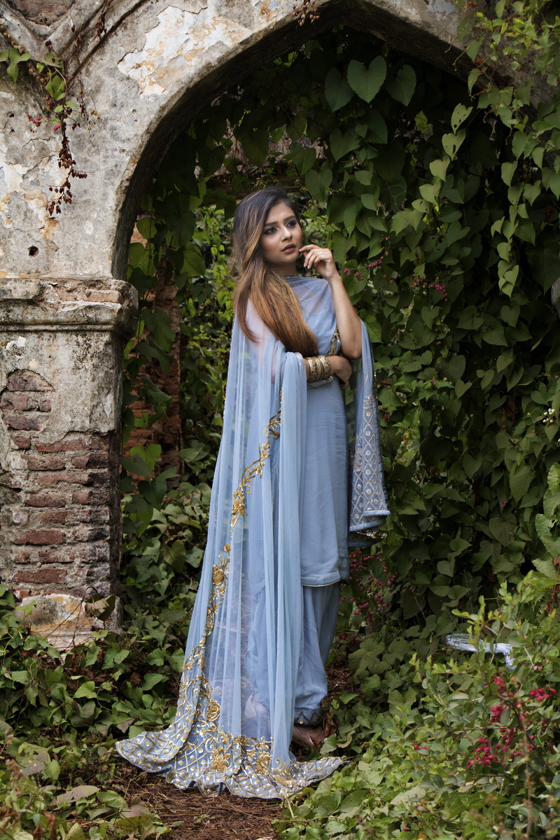 looking at camera, standing, arbor, hairstyle, plant, one person, pretty, vines, facial expression, arch, female, surrounded, dress, beautiful, person