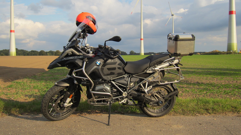 landscape, sky, mode of transportation, transportation, grass, road, machine, travel, environment, day, wheel, land vehicle, land, motorcycle, no people