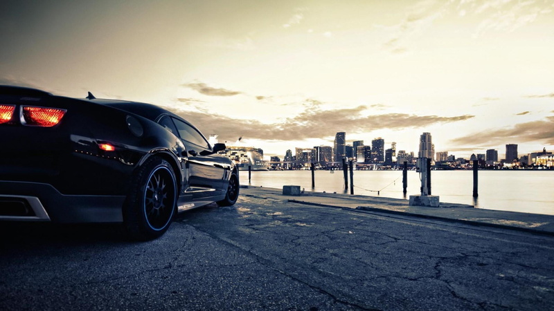 building, wheel, building exterior, sunset, chevrolet, land vehicle, office building exterior, city, transportation, cityscape, mode of transportation