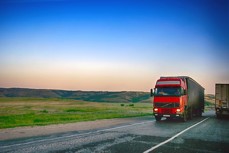 red, way, traffic, freight transportation, outdoors, environment, land vehicle, business, highway, no people, road trip, logistic, copy space, moving, cloud - sky