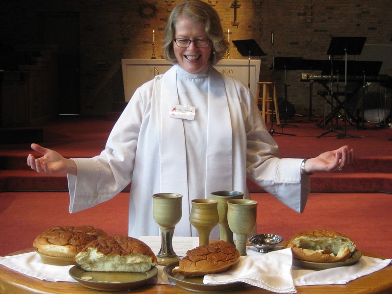 leavened, women, christianity, waist up, 1080P, indoors, eucharist, sweet food, priest, wine, cup, front view, crucifix, casual clothing, sacrament, smiling