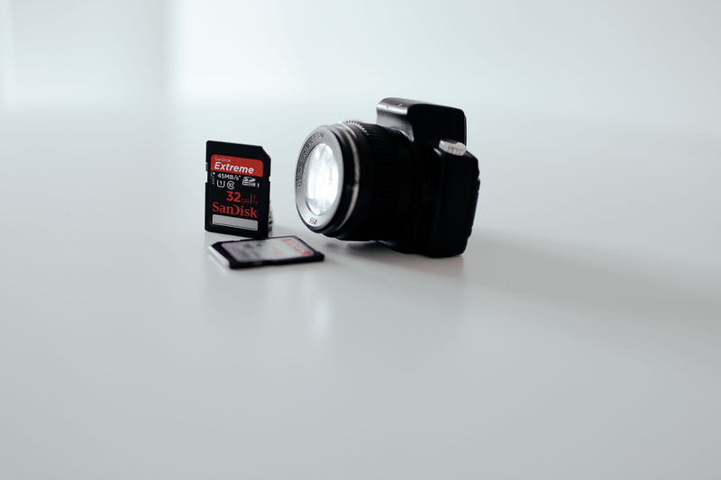 text, no people, technology, sd, photographic equipment, sd card, lens - optical instrument, close-up, black, studio, number, toy, equipment, single object