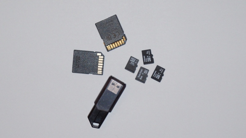 black color, connection, group of objects, large group of objects, sd card, usb stick, sd, close-up, still life, directly above, studio shot, communication