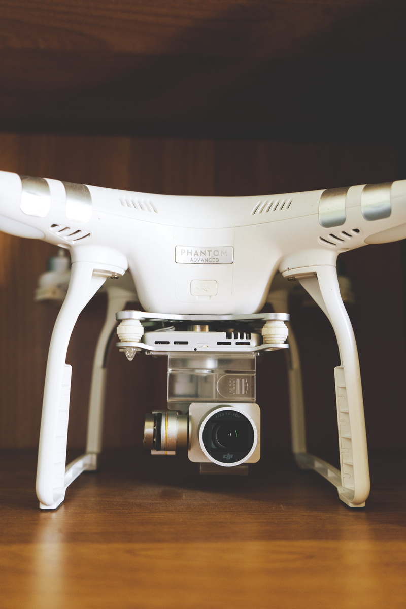 appliance, phantom, indoors, gear, drone photography, photographic equipment, brown, flooring, drone, metal, white, device, technology, wood - material