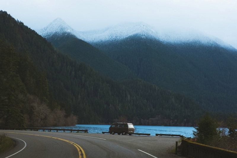 road, tree, forest, water, car, transportation, black, mountain, blue, nature, day, mode of transportation, fishing, motor vehicle, plant, road trip, no people