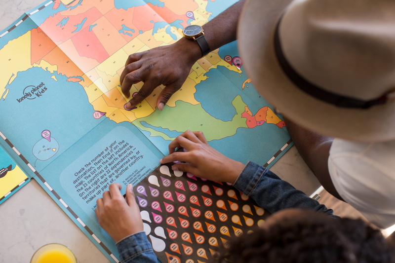 table, pointing, learning, kid, adult, planning, creativity, holding, map, californium, finger, child, teacher, nevada, discovery, women, human body part