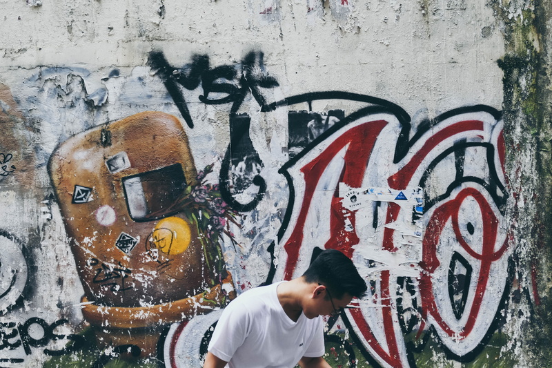 hong kong, art and craft, lifestyles, wall - building feature, day, portrait, outdoors, built structure, standing, creativity, communication, street art