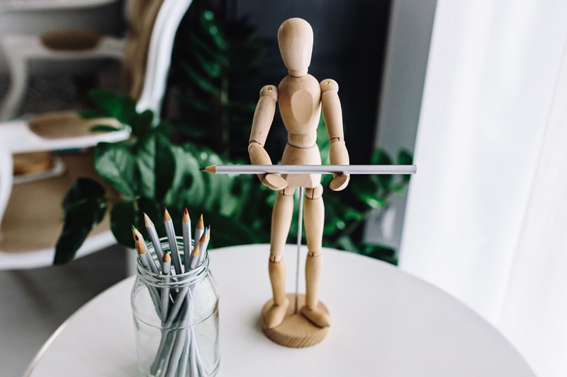 Artist, religion, representation, belief, young adult, no people, wood - material, spirituality, chair, focus on foreground, table, figurine, craft, still life