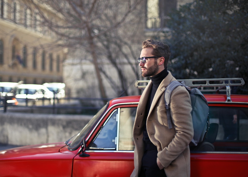 city, day, real people, beige, camel overcoat, jacket, beside, road, lifestyles, modern, standing, specs, bag, overcoat, walking, clothing, seen, focus on foreground