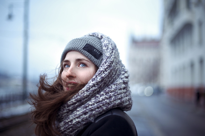 headshot, selective, human, looking at camera, young adult, city, outdoors, photography, blue, hat, gray, beautiful woman, hood, warm clothing, portrait