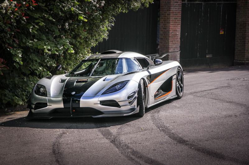 photography, luxury, front view, coupe, racing car, 5K, city, daytime, modern, built structure, day, building exterior, chrome, no People, outdoors, stationary