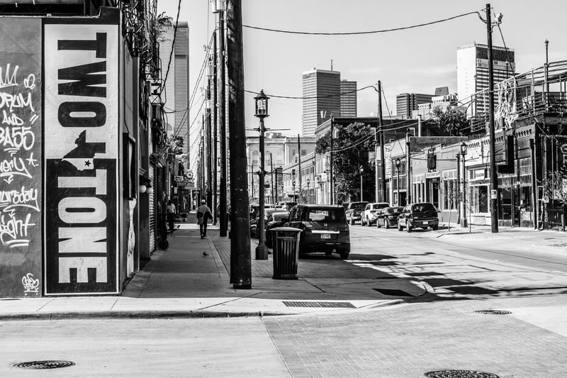 communication, grayscale, built structure, photograph, Downtown, City, western script, text, residential, poverty, neighborhood, building, Street, sky