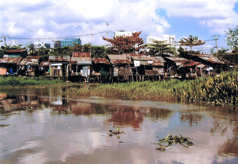 outdoors, slums, day, sky, tree, city, no people, residential district, brown, built structure, saigon, building exterior, culture, house, photography