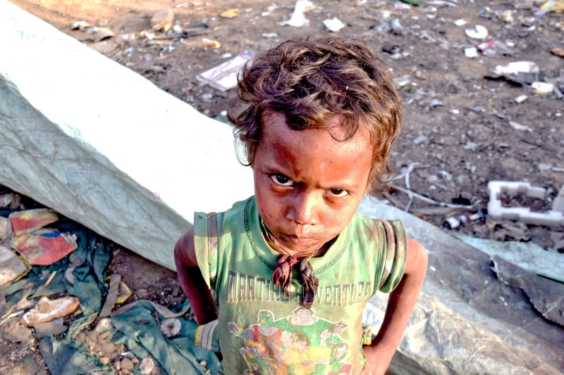 day, slums, dirty, outdoors, men, child, leisure activity, dirt, lifestyles, front view, india, young, boys, one person, cute, boy, expression, portrait