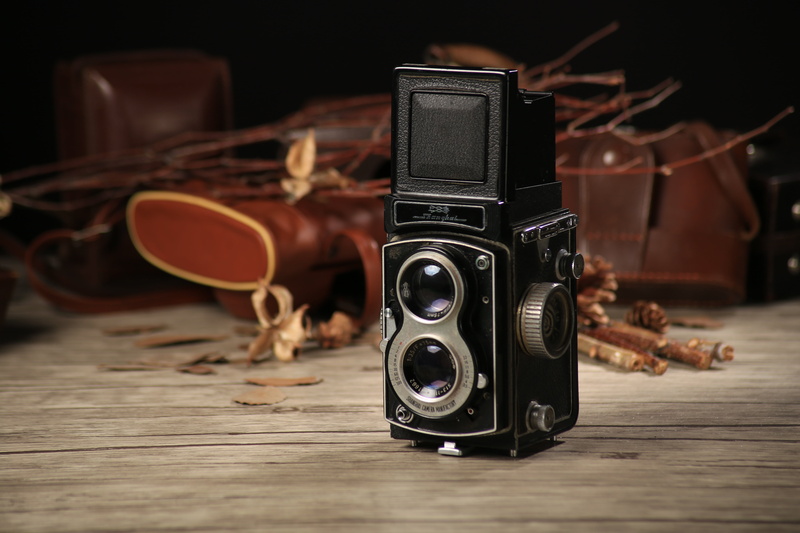retro styled, twin-lens reflex camera, still life, photograph, old camera, leather, nostalgia, rolleiflex, creativity, indoors, obsolete, table, focus on foreground