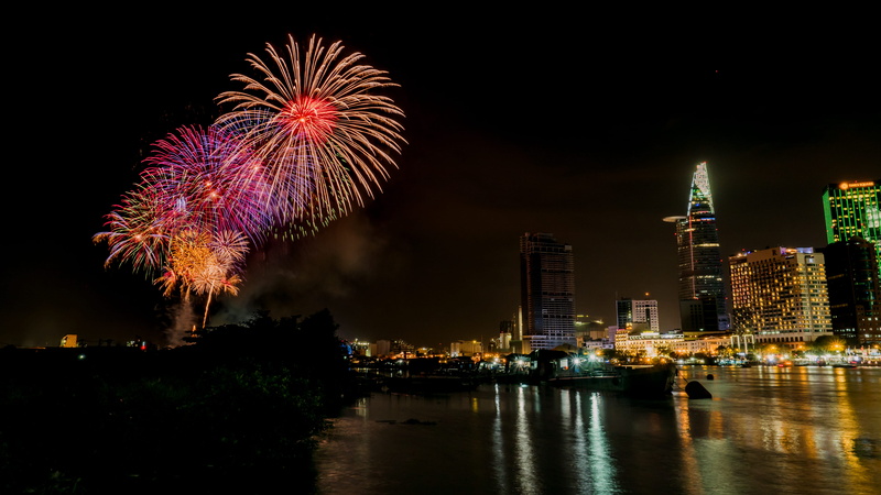 firework display, arts culture and entertainment, office building exterior, newyear, city, event, building, holiday, fireworks, vietnam, eve, cityscape