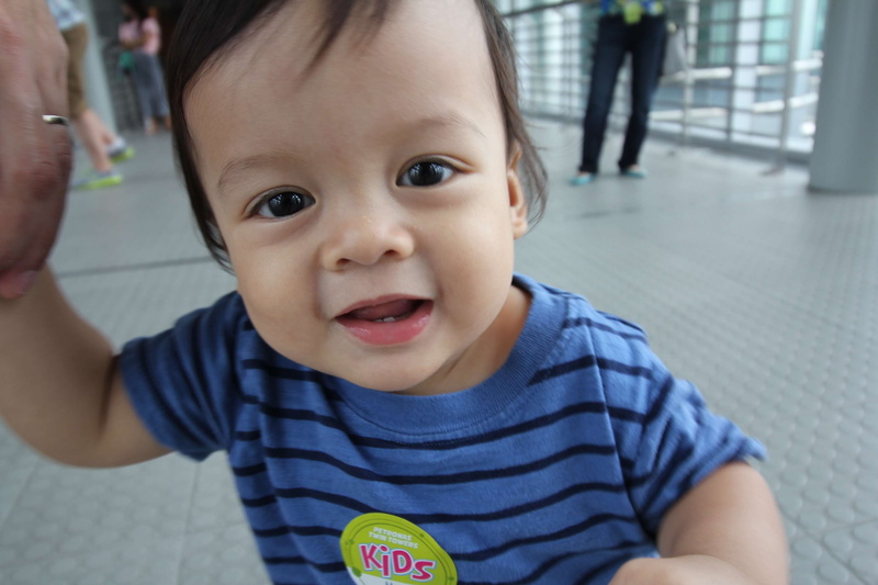 real people, one person, innocence, toddler, cute, boys, petronas twin towers, mouth open, asian, looking at camera, 2K, close-up, kid, filipino, males