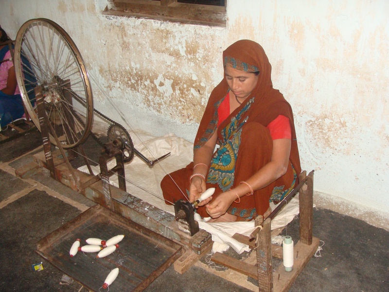 sitting, young adult, outdoors, leisure activity, wall - building feature, women, coarse cloth, garag, three quarter length, adult, weaving, village industry