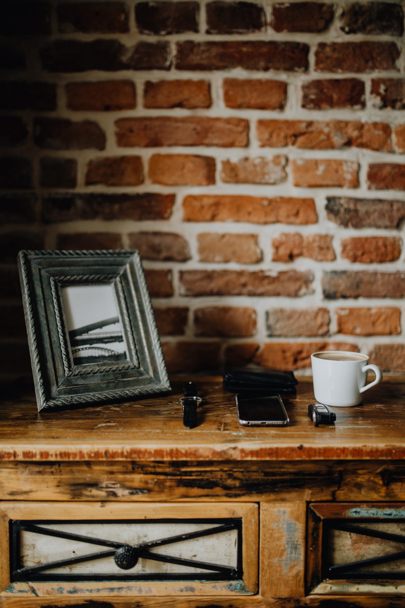 brick wall, brick, wood, technology, cup, indoors, still life, domestic room, coffee - drink, wall - building feature, commode, furniture, mug, interior