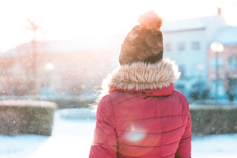 coat, adult, girl, waist up, nature, snowing, hat, leisure activity, day, lens flare, cold, extreme weather, focus on foreground, shining, warm clothing