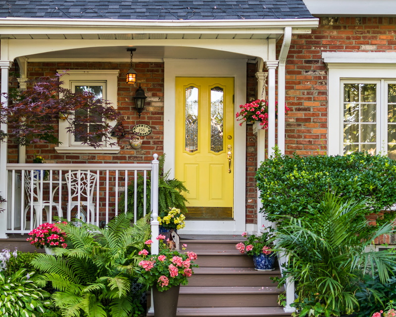 potted plant, brick, fern, window box, outdoors, staircase, entrance, flower pot, built structure, building exterior, no people, railing, housing, cottage