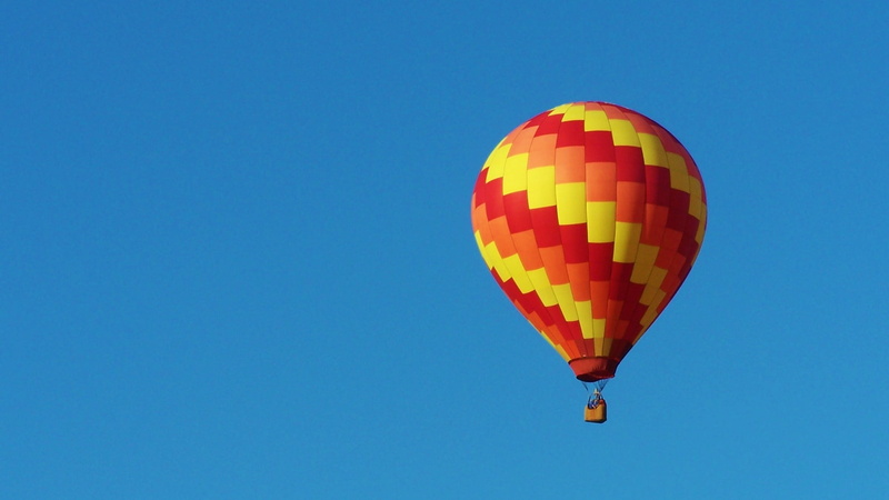 yellow, sky, recreation, airship, aviation, blue, nature, air, balloon, red, blue sky, adventure, low angle view, rise, mid-air, pattern, white, clear sky