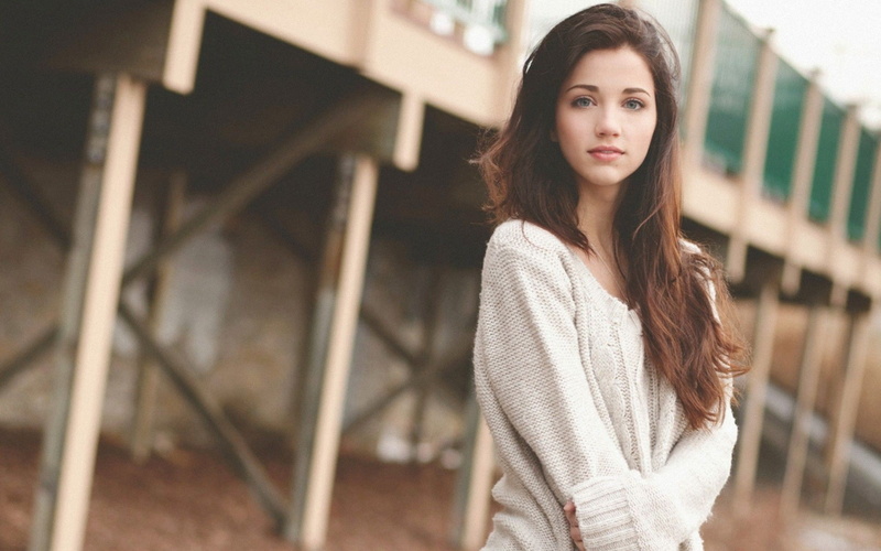 blue eyes, long hair, brunette, face, Emily Rudd, 1080P, arms crossed, urban, sweater, women, women outdoors, looking at viewer