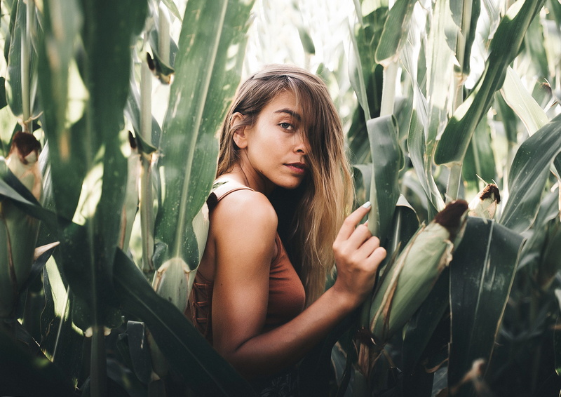 long hair, tanned, looking, day, hairstyle, contemplation, leisure activity, young adult, outdoors, real people, cornfield, teenager, beautiful woman, plant