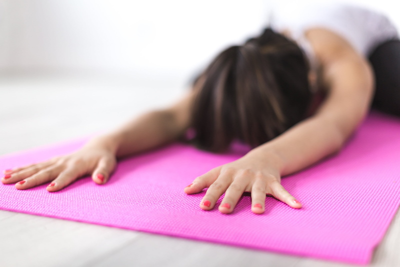 Health, indoors, restorative, Fitness, young adult, hand, Stretch, pink color, lying down, hairstyle, photo, Sports, exercise mat, relaxation, healthy lifestyle