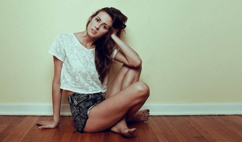 wood, one person, depression - sadness, flooring, hair, young adult, beauty, on the floor, clothing, young women, hardwood floor, legs, sitting, fashion