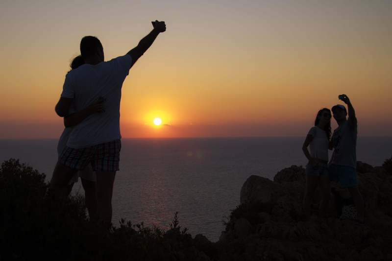 men, silhouette, sunset, young couples, orange color, beach, land, lifestyles, zakynthos, rear view, horizon over water, outdoors, standing, nature, selfie obsession