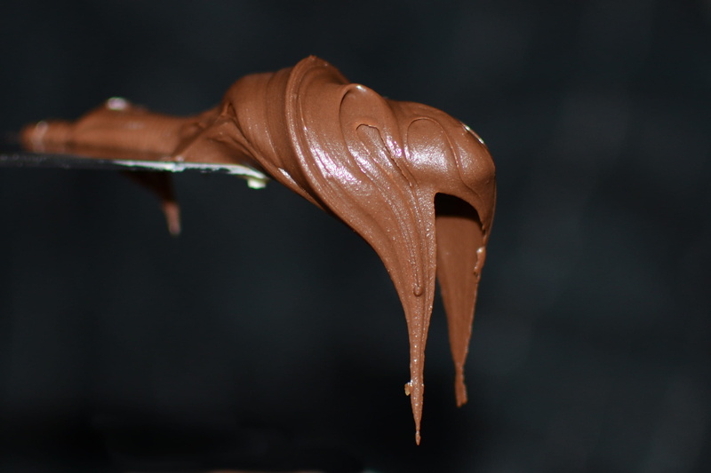 no people, dip, string, arts culture and entertainment, close-up, black background, nibble, chocolate, 2K, indulgence, studio shot, selective focus, food