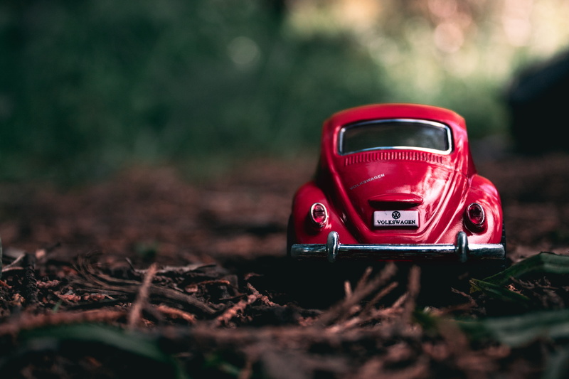 no People, mode of transportation, nature, forest, grass, outdoors, toy, cast, field, toy car, driving, model, engine, retro Styled, land Vehicle, close-up