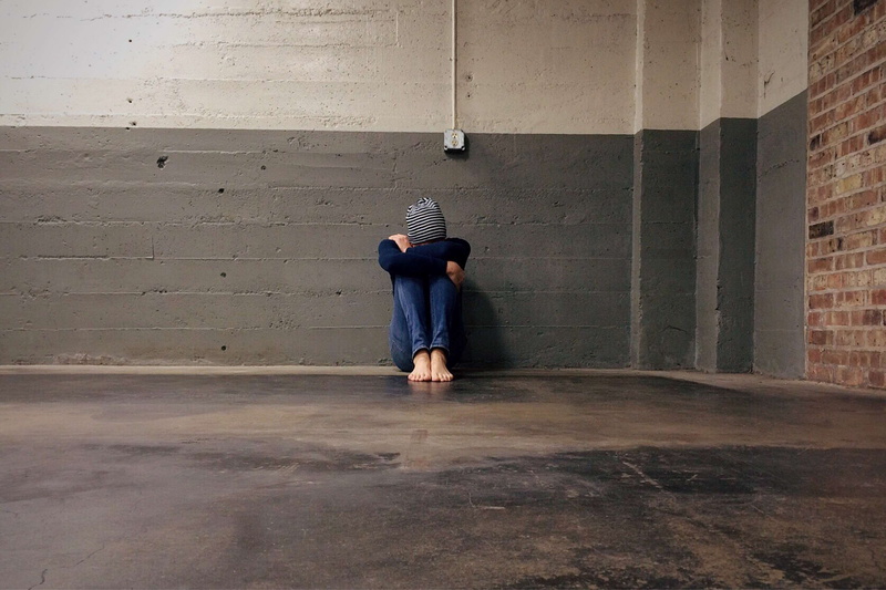 two people, young adult, wall - building feature, lonely, people, male, concrete, brick, men, building, brick wall, alone, casual clothing, front view