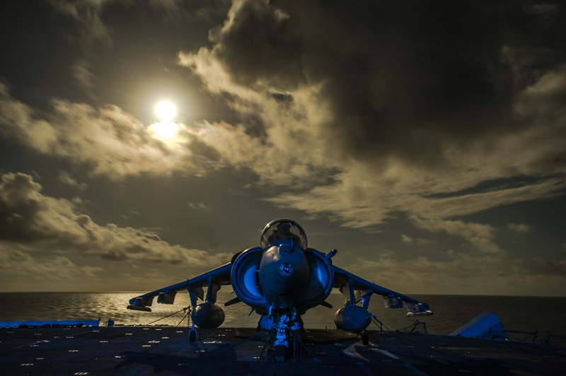 land, near, leisure activity, cloud - sky, av-8b harrier ii, plane, front view, outdoors, clouds, usa, air vehicle, ocean, moonlight, flight deck, one person